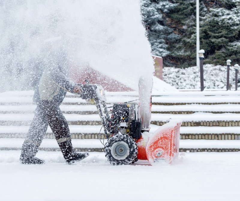 An ice control machine clearing snow and ice from a road