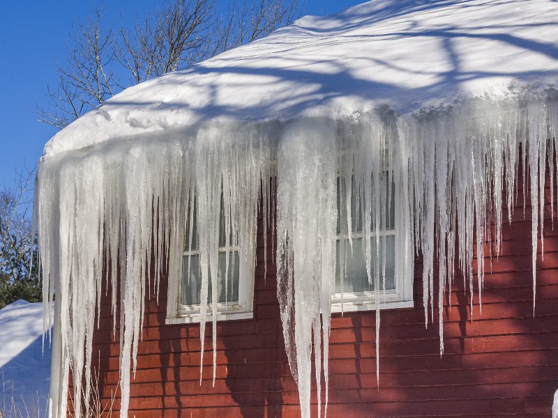 An ice dam being removed from a roof