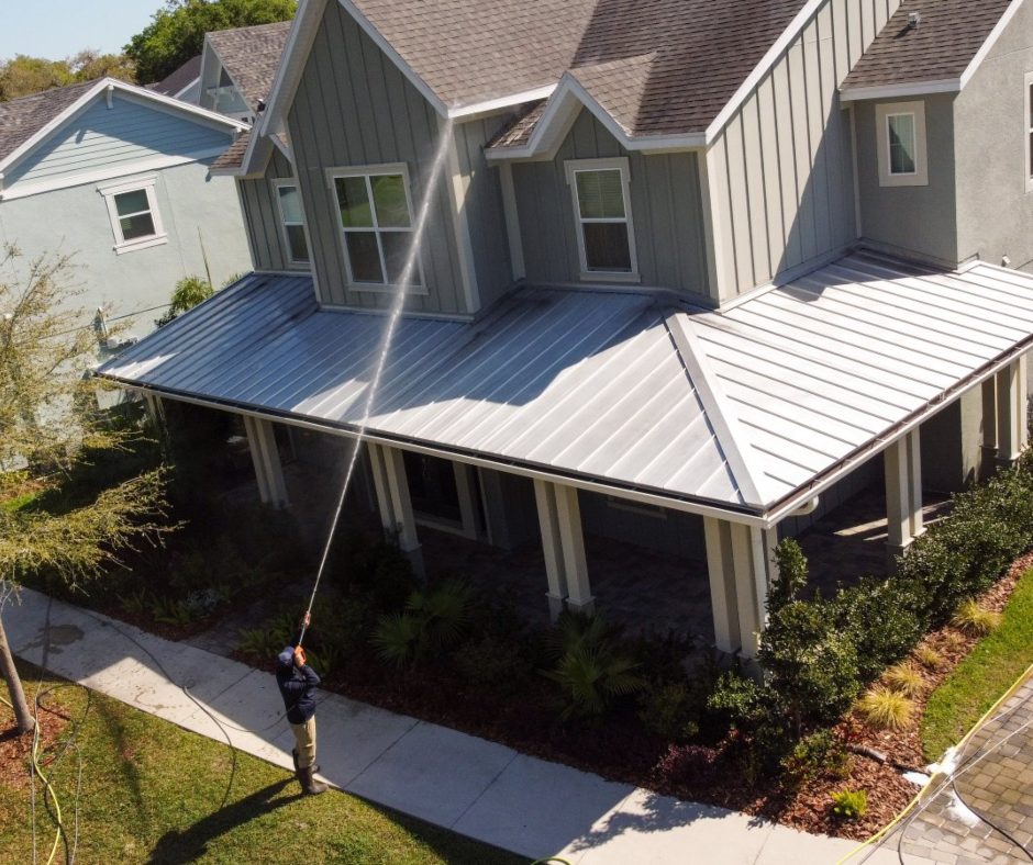 a power washer being used to clean a house exterior